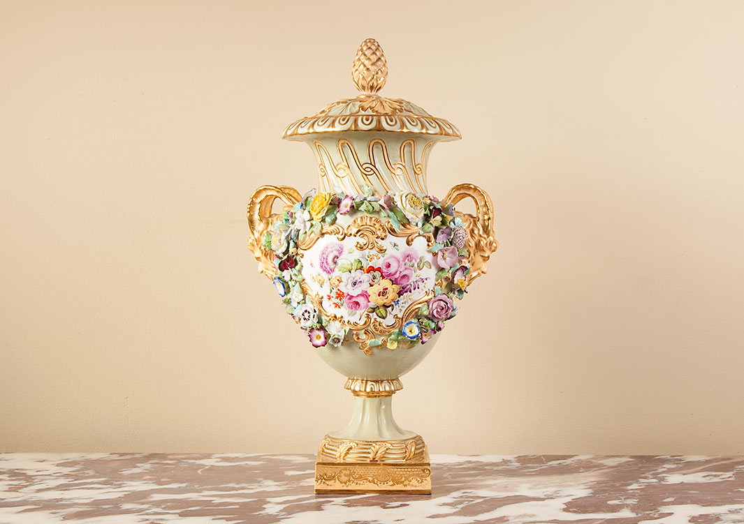 A late 19th century classical porcelain urn with pained scenes of birds and flowers.