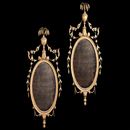 A pair of late 18th century neo-classical ,carved and giltwood oval mirrors with original plates.